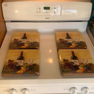 Set of four gas burner stove covers. Wine Decour.